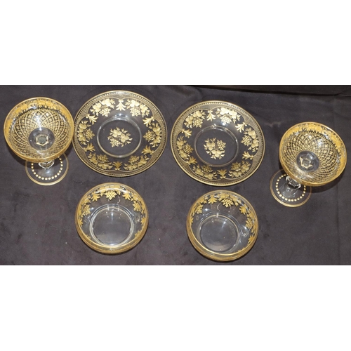 122 - A pair of clear cut glass champagne glasses with gilt, floral and leaf decoration and a pair of simi... 