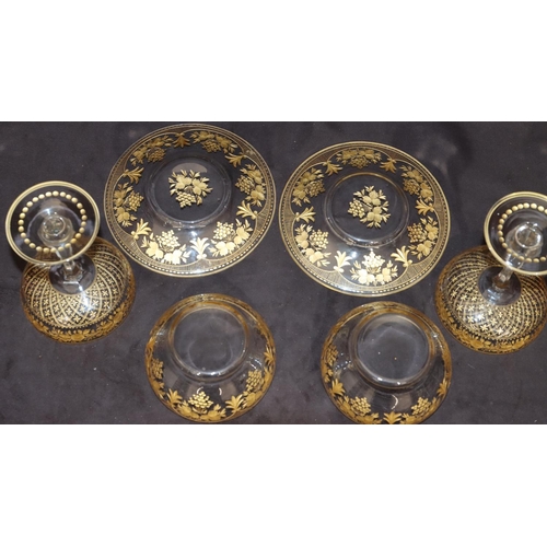 122 - A pair of clear cut glass champagne glasses with gilt, floral and leaf decoration and a pair of simi... 