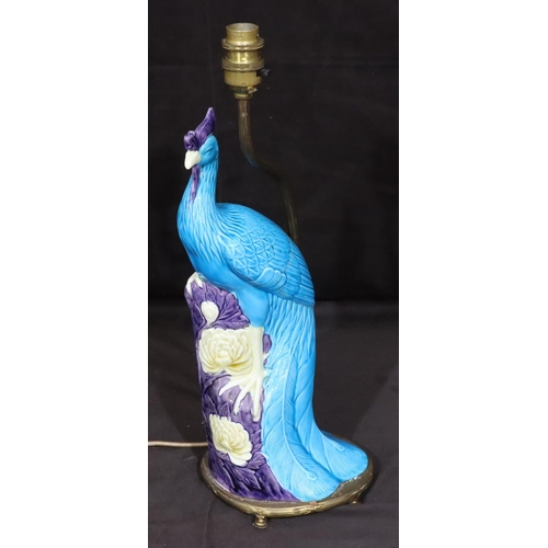 128 - An Oriental table lamp in the form of a perched bird on purple, turquoise and white ground, mounted ... 