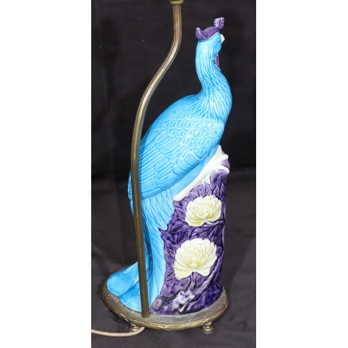 128 - An Oriental table lamp in the form of a perched bird on purple, turquoise and white ground, mounted ... 