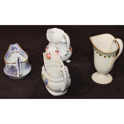 13 - A Wedgwood helmet shaped cream jug with multi-coloured strawberry and leaf decoration, 15.5cm high, ... 