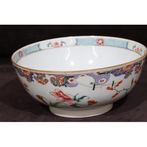 130 - A 19th Century Chinese round bowl with multi-coloured floral, leaf and scroll decoration (rim cracke... 