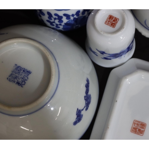 131 - An Oriental small blue and white round bowl with tree decoration, 11.5cm diameter, a pair of miniatu... 