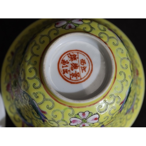 133 - A Chinese round bowl with cover and saucer on yellow ground with multi-coloured bat, scroll, floral ... 