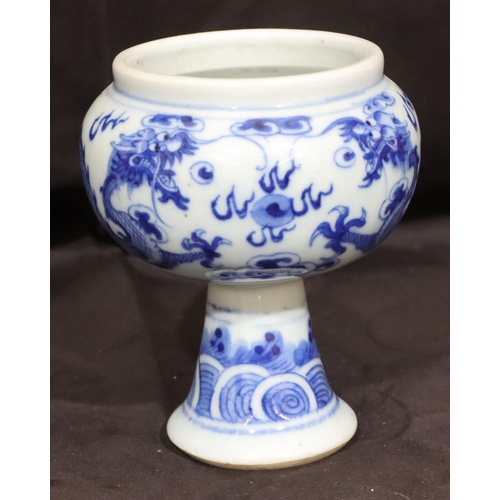 137 - A 19th Century Oriental blue and white round bulbous shaped pot with dragon decoration, on round tap... 