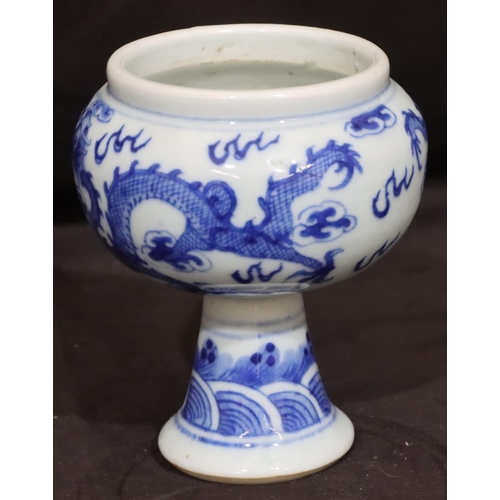 137 - A 19th Century Oriental blue and white round bulbous shaped pot with dragon decoration, on round tap... 