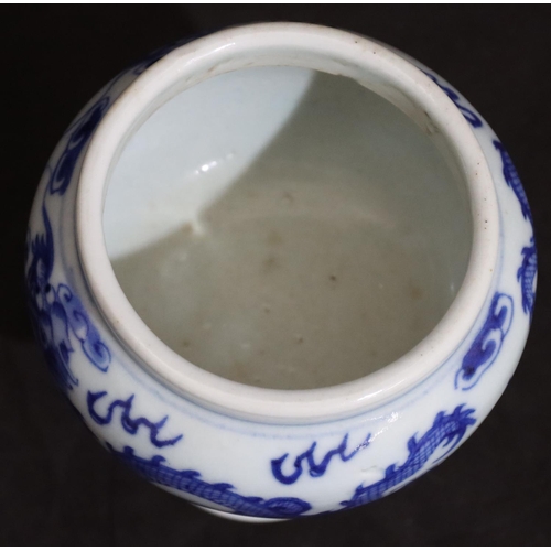 137 - A 19th Century Oriental blue and white round bulbous shaped pot with dragon decoration, on round tap... 