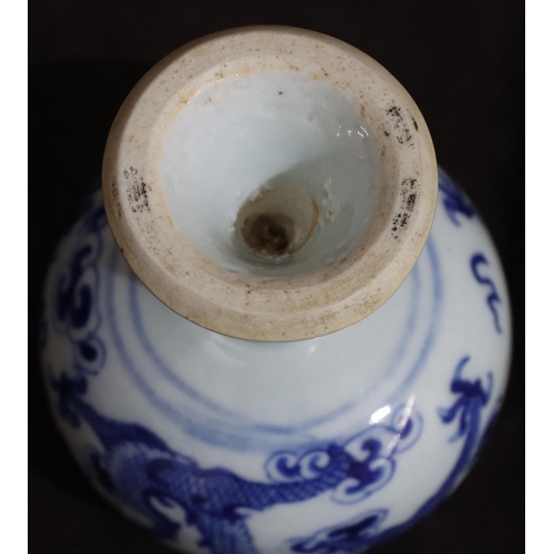 137 - A 19th Century Oriental blue and white round bulbous shaped pot with dragon decoration, on round tap... 