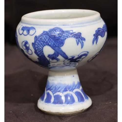 138 - A 19th Century small round bulbous shaped pot on blue and white ground with dragon decoration, on ro... 