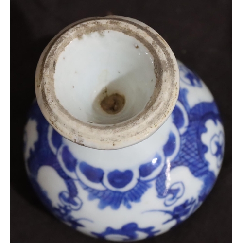 138 - A 19th Century small round bulbous shaped pot on blue and white ground with dragon decoration, on ro... 