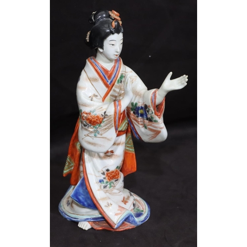 144 - An Oriental china figure of a standing Geisha girl, 23.5cm high (left hand restored)