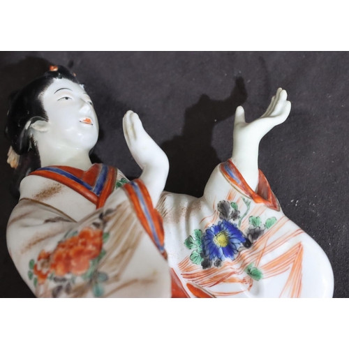 144 - An Oriental china figure of a standing Geisha girl, 23.5cm high (left hand restored)