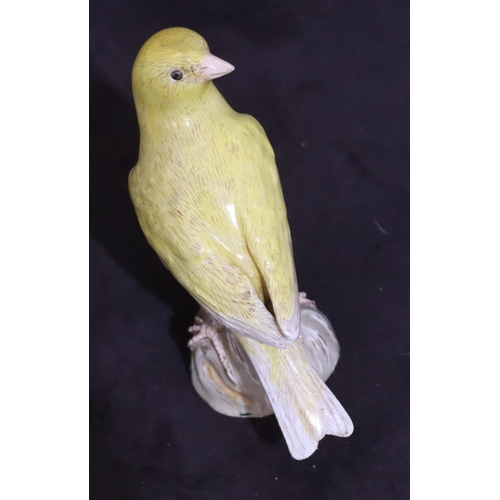 151 - A 19th Century Meissen figure of a yellow bird perched upon trunk (trunk restored), 10cm high