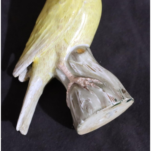 151 - A 19th Century Meissen figure of a yellow bird perched upon trunk (trunk restored), 10cm high