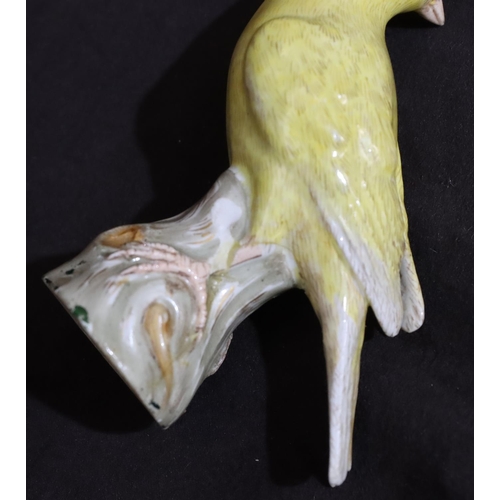 151 - A 19th Century Meissen figure of a yellow bird perched upon trunk (trunk restored), 10cm high