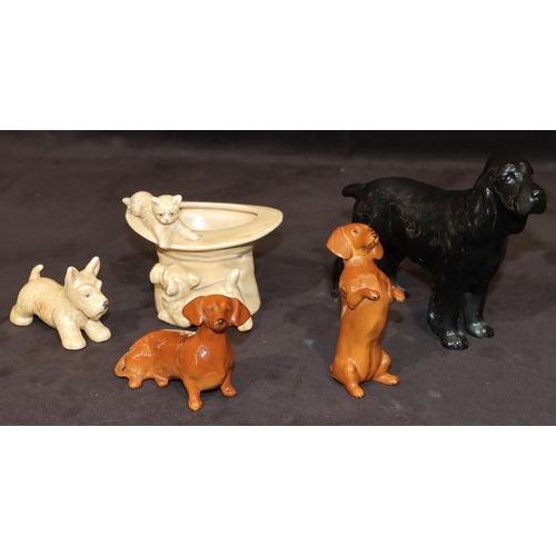 159 - A Beswick figure of a spaniel on black ground, 14cm high, 2 Beswick figures of seated begging Dachsh... 