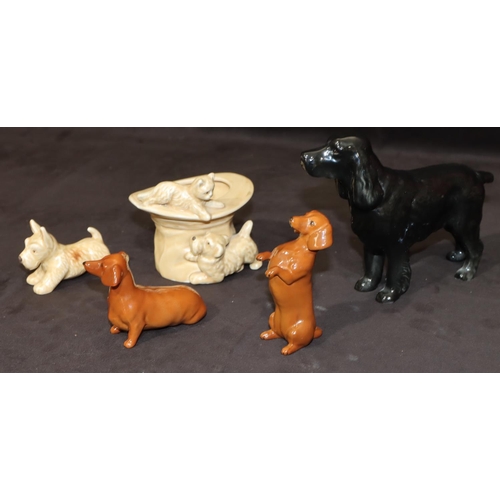 159 - A Beswick figure of a spaniel on black ground, 14cm high, 2 Beswick figures of seated begging Dachsh... 