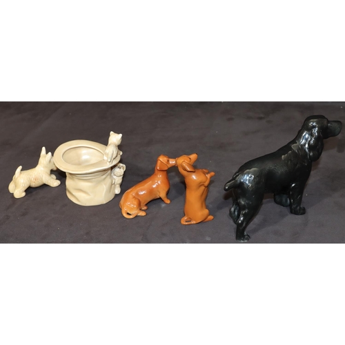 159 - A Beswick figure of a spaniel on black ground, 14cm high, 2 Beswick figures of seated begging Dachsh... 