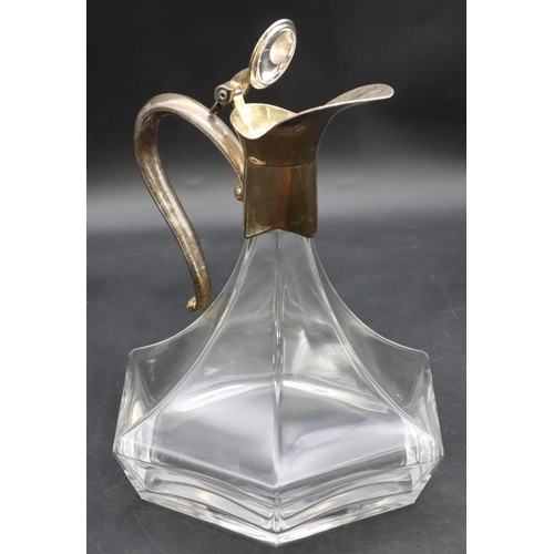 212 - An Arts & Crafts style glass bulbous shaped claret jug with silver plated neck, hinged lid and scrol... 