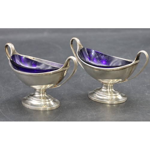 213 - A pair of London silver Victorian oval salts with blue glass liners on oval sweeping bases, 3oz, Lon... 