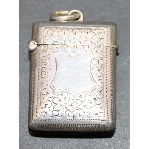 221 - A small Victorian silver vesta case with allover chased and leaf decoration and hinged lid, Birmingh... 