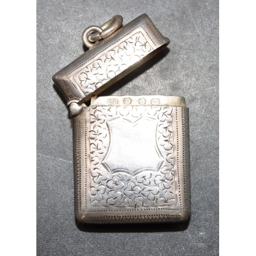 221 - A small Victorian silver vesta case with allover chased and leaf decoration and hinged lid, Birmingh... 