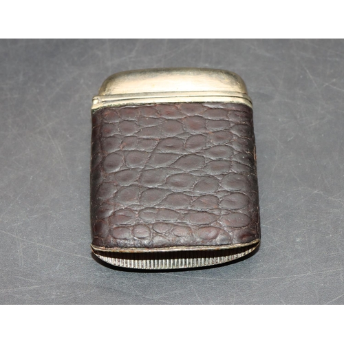 222 - A silver plated and leather vesta case with silver cartouche and hinged lid