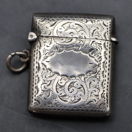 228 - An Edwardian silver vesta case with chased scroll and leaf decoration and hinged lid, Birmingham 190... 