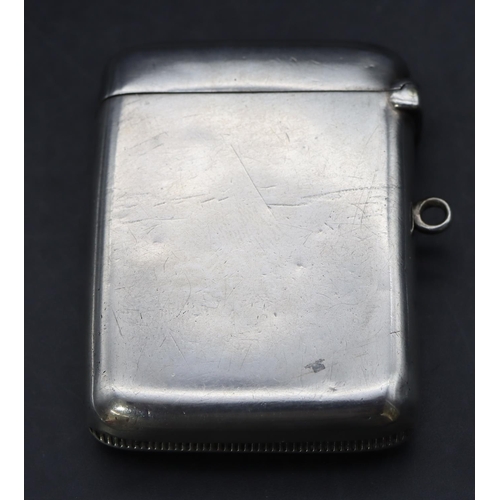 229 - An Edwardian plain Birmingham silver vesta case with hinged lid and enamelled crest motif inscribed ... 