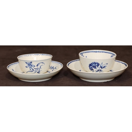 23 - An 18th Century Worcester blue and white tea bowl and saucer with allover floral and leaf decoration... 