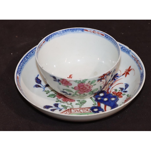 24 - An 18th Century Lowestoft tea bowl and saucer on blue and red ground with multi-coloured fence, flor... 