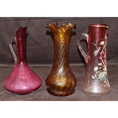 30 - A ruby tall glass jug with painted floral and leaf decoration, 33cm high, a ruby glass bulbous shape... 