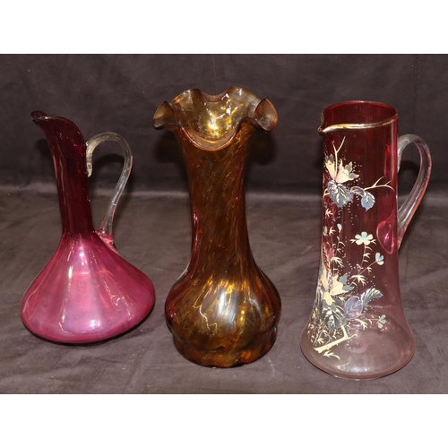 30 - A ruby tall glass jug with painted floral and leaf decoration, 33cm high, a ruby glass bulbous shape... 