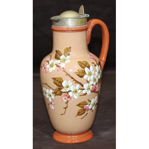 34 - A Victorian glazed earthenware round bulbous jug with silver plated neck and hinged lid on brown gro... 