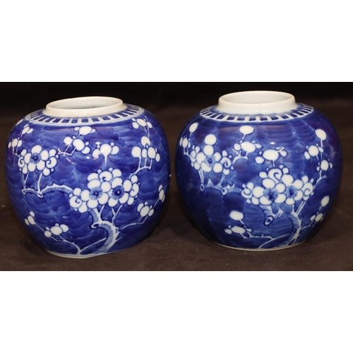 35 - A pair of Oriental round bulbous ginger jars (no covers) with branch and blossom decoration, 12cm hi... 