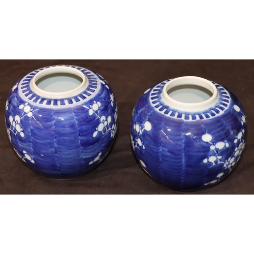 35 - A pair of Oriental round bulbous ginger jars (no covers) with branch and blossom decoration, 12cm hi... 