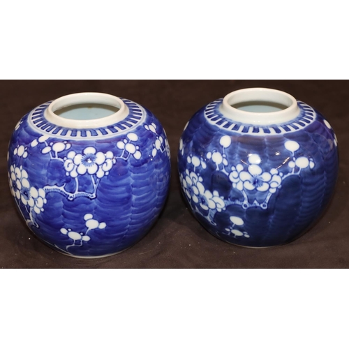 35 - A pair of Oriental round bulbous ginger jars (no covers) with branch and blossom decoration, 12cm hi... 