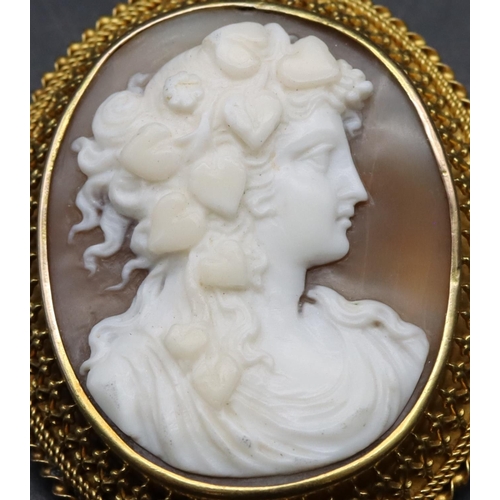 395 - A 19th Century oval gold frame cameo with raised figurehead of a lady with hearts plaited in her hai... 