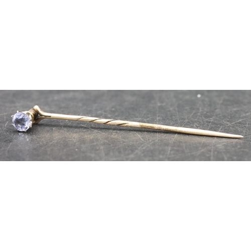 396 - A gold stickpin mounted with a pale blue stone, 1.6 grams gross