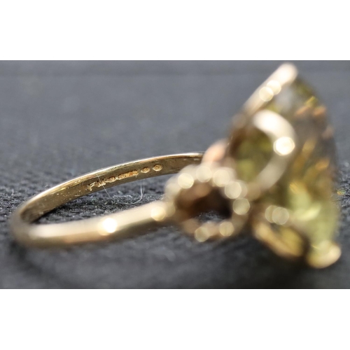 403 - A 9ct gold ladies' ring set with yellow stone with circular shaped shoulders, size O, 4.3 grams gros... 