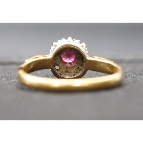 408 - An 18ct gold ladies' small cluster ring set with centre ruby surrounded by small diamonds (cut), siz... 