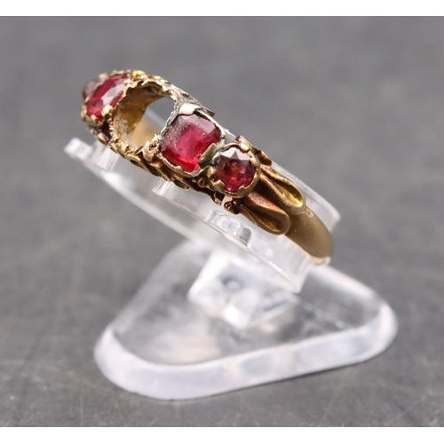 411 - A 15ct gold ladies' 5-stone ring (centre stone missing), flanked by 4 red stones, size O, 1.6 grams ... 