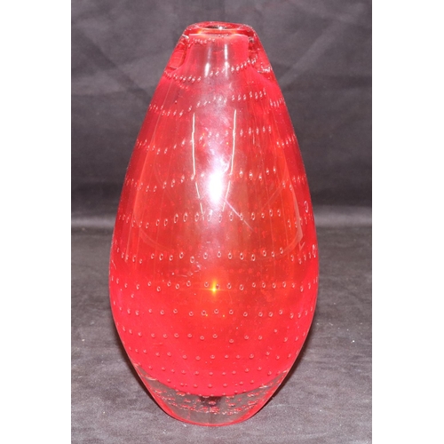 42 - A heavy red glass round bulbous thin necked vase with inner ball decoration, 25cm high