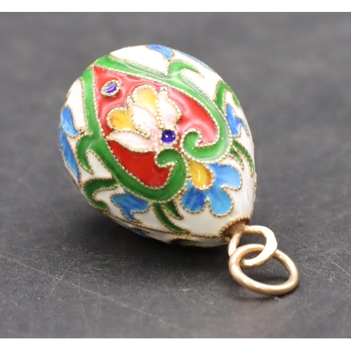 424 - A Russian enamelled and silver gilt pendant in the form of an egg, 3.3cm high