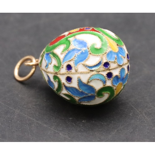 424 - A Russian enamelled and silver gilt pendant in the form of an egg, 3.3cm high