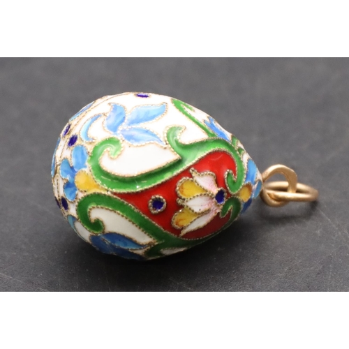 424 - A Russian enamelled and silver gilt pendant in the form of an egg, 3.3cm high