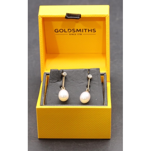 425 - A pair of 9ct gold ladies' pearl drop earrings mounted with small diamonds