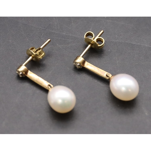 425 - A pair of 9ct gold ladies' pearl drop earrings mounted with small diamonds