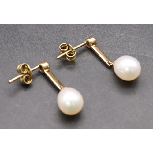 425 - A pair of 9ct gold ladies' pearl drop earrings mounted with small diamonds