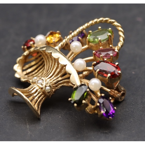 426 - A 9ct gold brooch in the form of a basket mounted with various coloured stones, overall weight 5.6 g... 